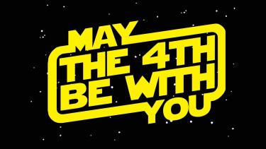 may the 4th be with you sign in yellow on a black background