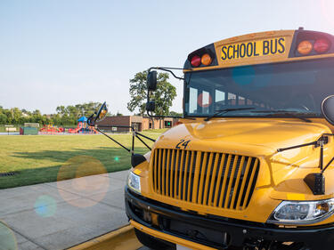 school bus parked in front of a field