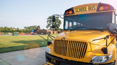 school bus parked in front of a field