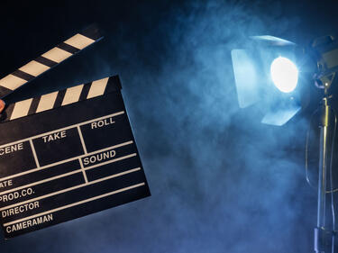 a director's board with a movie light in the background