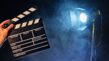 a director's board with a movie light in the background
