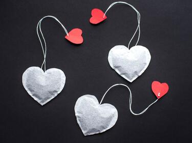 heart shaped tea bags hanging by a string with red heart cutouts.