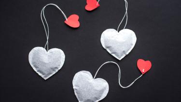 heart shaped tea bags hanging by a string with red heart cutouts.