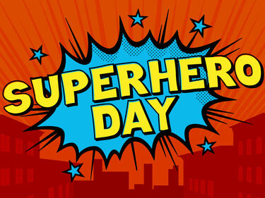 superhero day sign with a red background