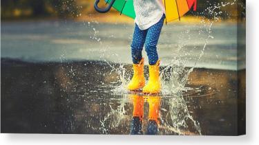 child playing in a puddle