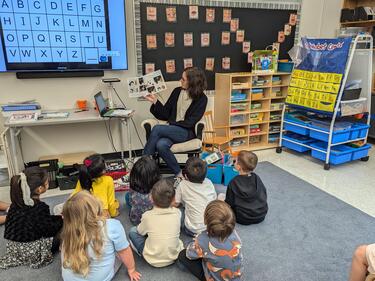 Kindergarten students are enjoying story time. 